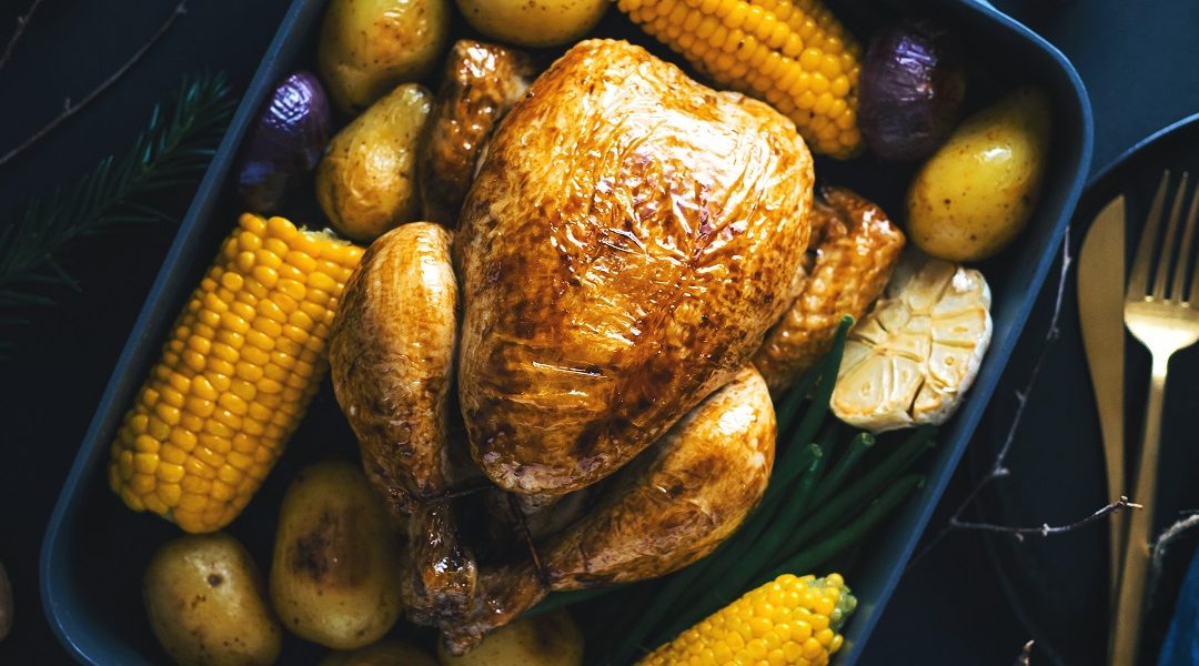 Christmas dinner table with chicken on dark